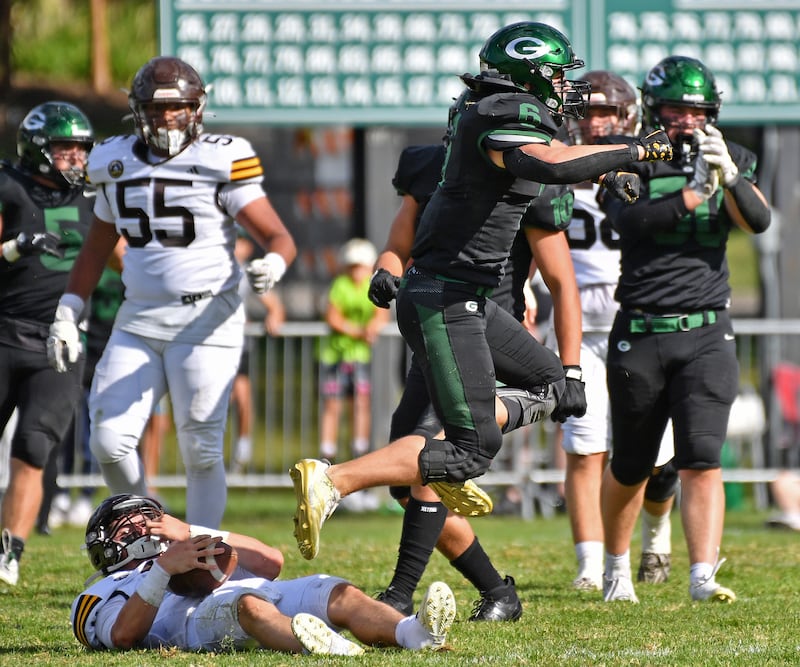 Glenbard West’s Scott Segebarth (6) leaps in celebration after sacking Joliet Catholic quarterback Lucas Simulick during a game on September 6, 2025 at Glenbard West High School in Glen Ellyn.
