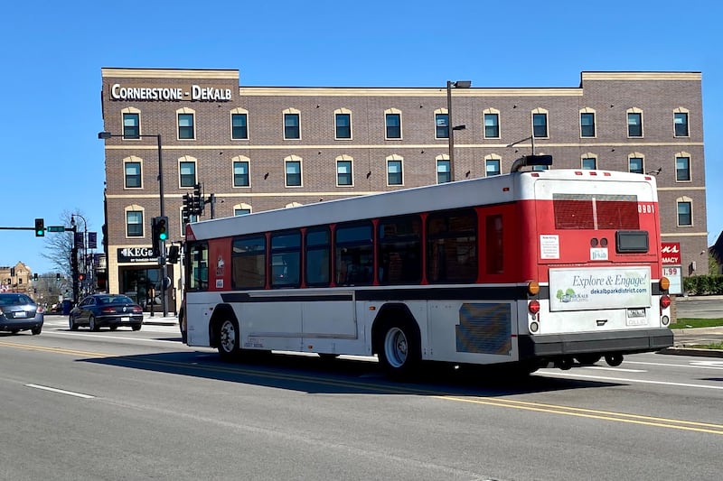 An NIU Huskie bus, part of the city of DeKalb's public transit system, heads east on Lincoln Highway in downtown DeKalb Monday, April 15, 2024.