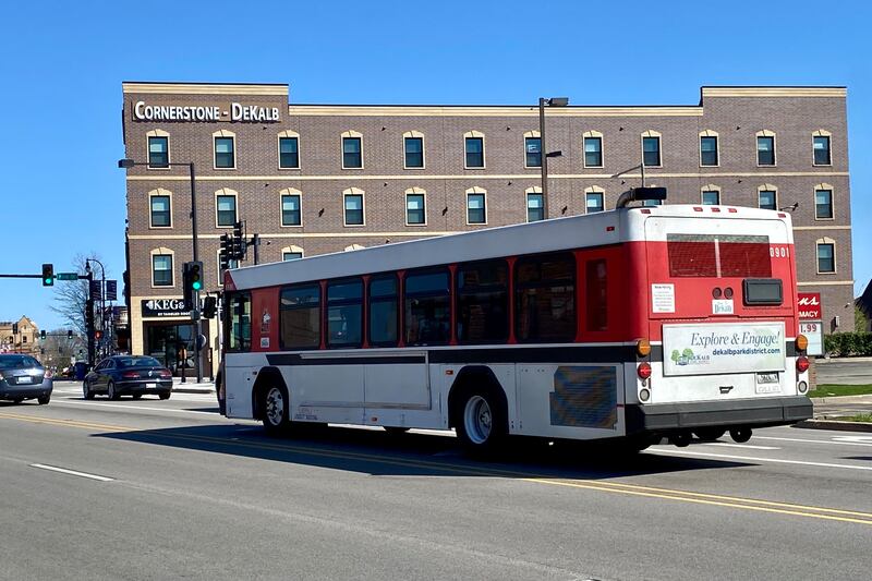 An NIU Huskie bus, part of the city of DeKalb's public transit system, heads east on Lincoln Highway in downtown DeKalb Monday, April 15, 2024.
