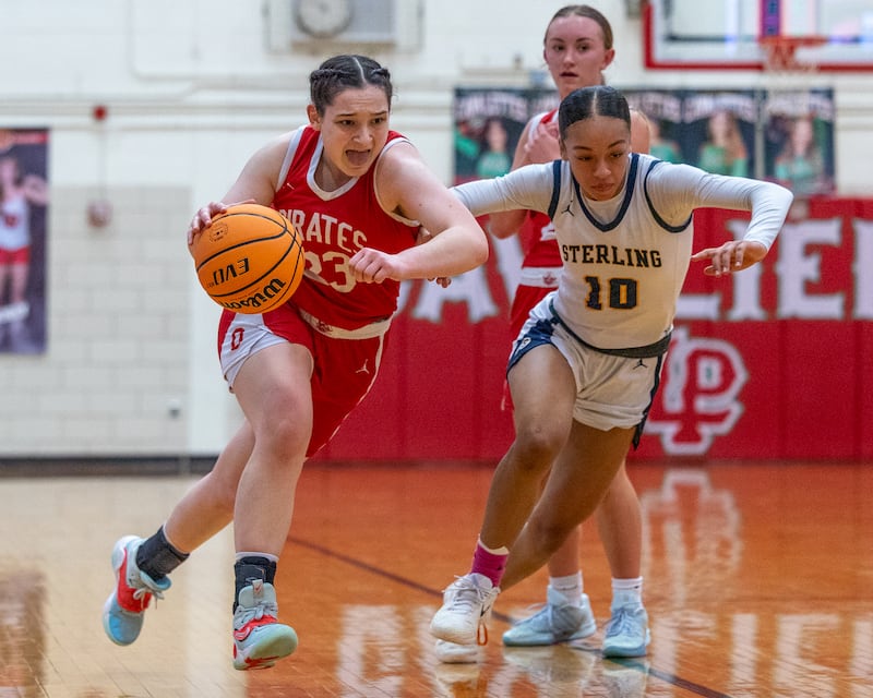 Ottawa's Mary Stisser (23) pushed the ball up the court as Sterling defender Nia Harris (10) races to keep up Thursday, Feb. 19, 2026, during the Class 3A La Salle-Peru Regional championship game in Sellett Gymnasium in La Salle.