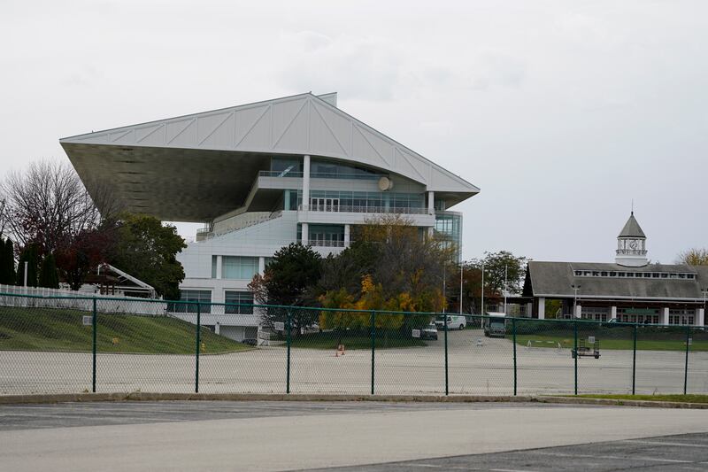 The grandstand at Arlington International Racecourse is seen from a parking lot in Arlington Heights, Ill., Friday, Oct. 14, 2022. The Chicago Bears want to turn the Arlington Heights site, once a jewel of thoroughbred racing, into a different kind of gem, anchored by an enclosed stadium and bursting with year-round activity — assuming a deal with Churchill Downs Inc. to buy the land goes through. They envision restaurants, retail and more on the plot of land some 30 miles northwest of their longtime home at Soldier Field — all for about $5 billion, with some taxpayer help. (AP Photo/Nam Y. Huh)