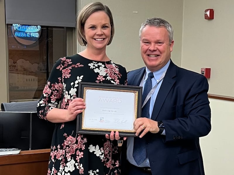Beth Swiderski, a volunteer with Lazarus House, receives a Spirit of St. Charles award from Mayor Clint Hull on Jan. 20, 2026.
