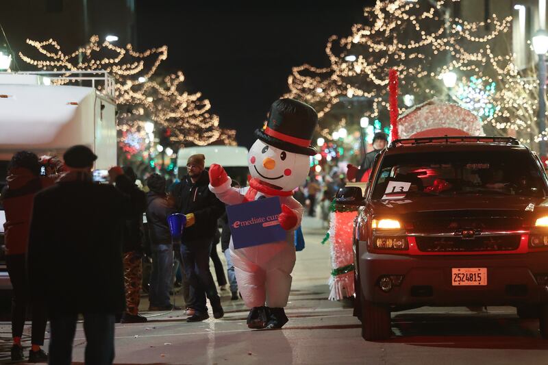 A snowman waves to the crowds at the Joliet Light up the Holidays Parade in downtown Joliet on Friday, Nov. 24, 2023.