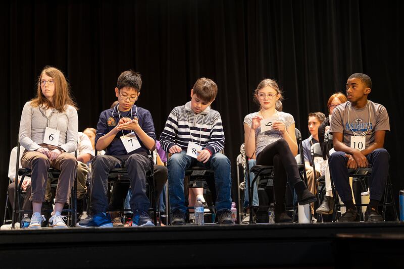 Spelling bee contestants spell out words as they wait their turn Thursday, Feb. 20, 2025, at the Lee, Ogle, Whiteside County Regional Spelling Bee.