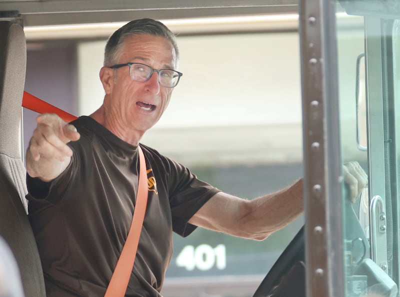 UPS Jim Bezley, waves good-bye to business owners and suppporters during his final delivery on Friday, .April 24, 2026 down Main Street in Streator. Bezley is retiring from UPS after 47 years. Bezley began working for UPS right out of high school in 1979.