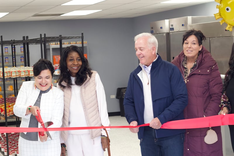 Joliet Township Supervisor Alicia Morales (left), cuts a red ribbon on Monday, April 21, 2025, for a ceremony recognizing the food pantry at the Joliet Township Forest Park Community Center. Standing next to Morales is Bettye Gavin, former executive director of the community center and Joliet City Council member, Joliet Mayor Terry D'Arcy, and Suzanna Ibarra, Joliet City Council member.