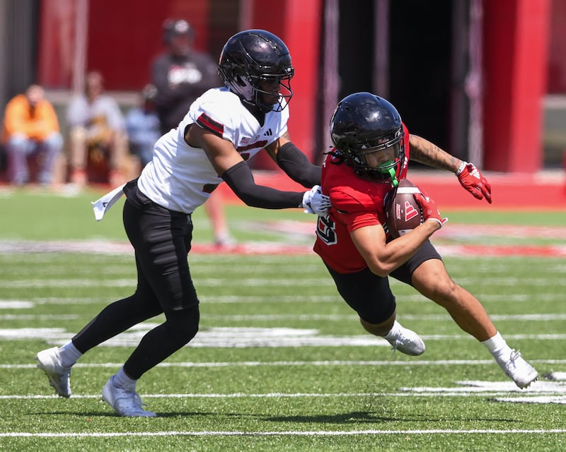 Northern Illinois University’s Samir Senenat, right, runs the ball after catching a pass while De’ion Reynolds defends him on Saturday April 26, 2025, during a practice held at Huskie Stadium in DeKalb.