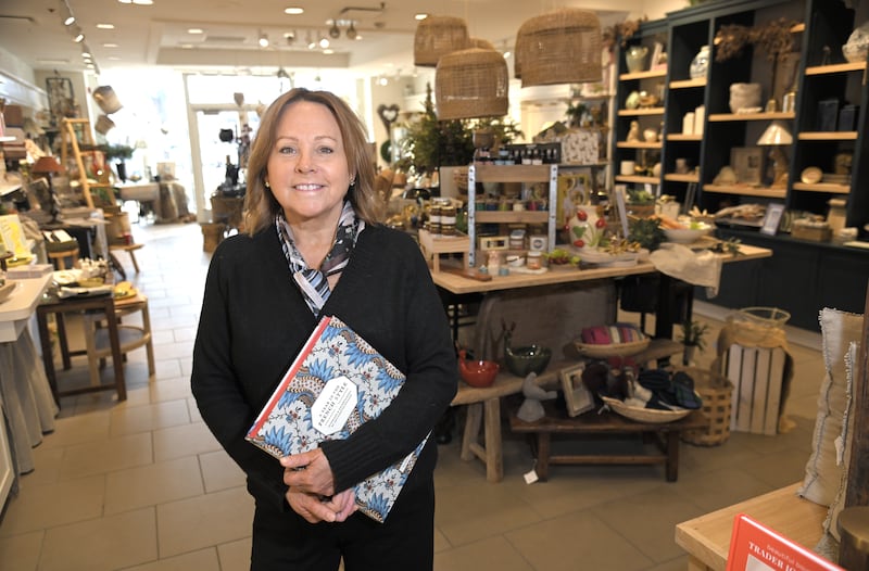 Fran Rouse poses in her Stonehouse Market business at 111 Town Square in Wheaton. She is opening another store in downtown Wheaton.