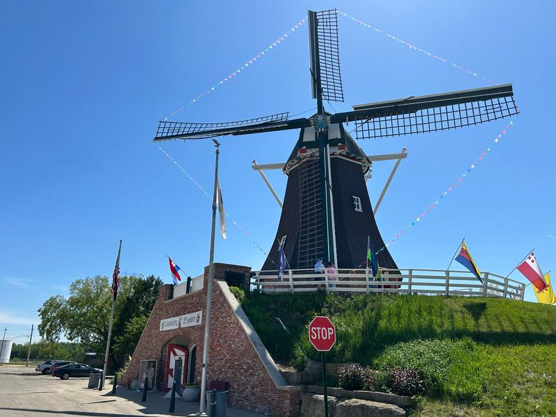 Visitors tour the de Immigrant Windmill in Fulton as it stands out against a clear blue sky on Sunday, May 11, 2025. The unique attraction is open Saturdays from 10 a.m. to 5 p.m. and Sundays from 1-5 p.m. The Windmill Cultural Center is located across the street from the windmill.