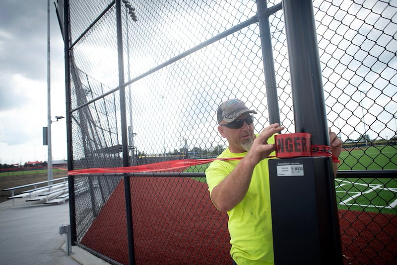 Adam Olson, director of maintenance at the 315 Sports Park in Bradley, ropes off a field on Friday July 11, 2025, that was damaged by strong winds the previous night.