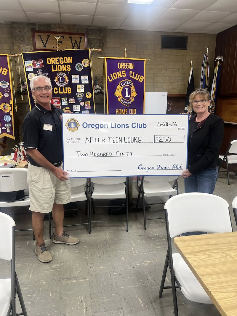 Oregon Lions Club President Grant Afflerbaugh (left) presents a donation to Paula Porter of the After Teen Lounge.