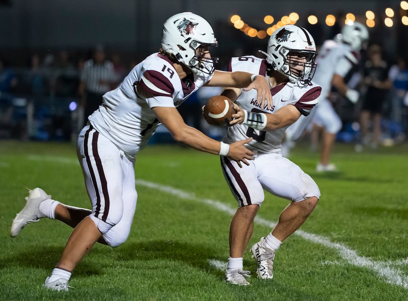 Prairie Ridge's Luke Vanderwiel hands the ball off to Jake Wagler during their game against Burlington Central on Friday, September 19, 2025 at Burlington Central High School. Ryan Rayburn for Shaw Local
