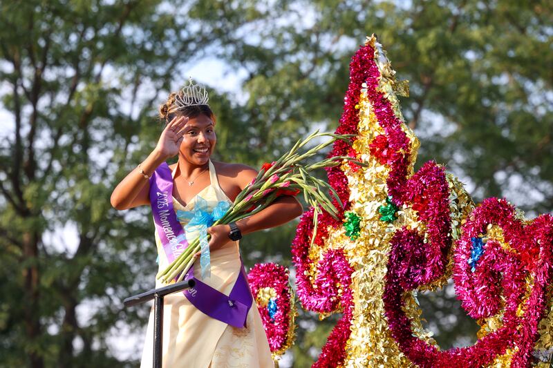Jennifer Corona, the 2025 Gladiolus Festival queen, waves to the crowd during the 87th Momence Gladiolus Festival Main Street Parade on Friday, Aug. 8, 2025.