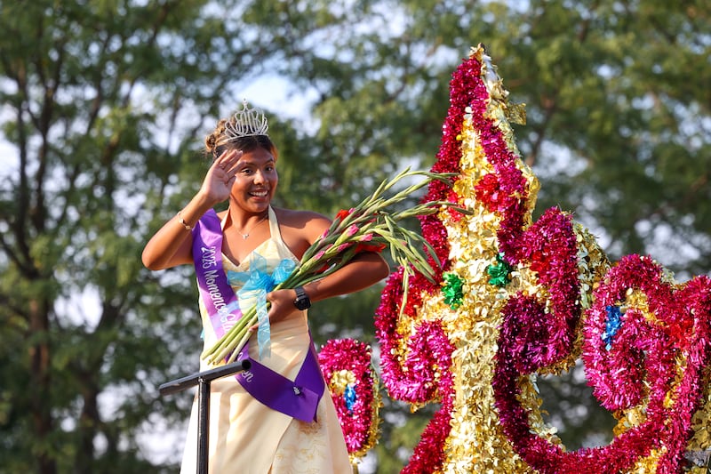 Jennifer Corona, the 2025 Gladiolus Festival queen, waves to the crowd during the 87th Momence Gladiolus Festival Main Street Parade on Friday, Aug. 8, 2025.