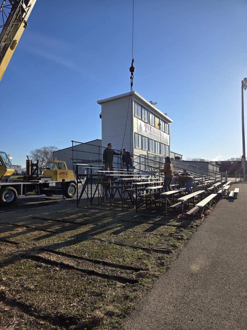 The old bleachers at The Harbor at Amboy High School sailed off to a new home March 28 as the district donated the bleachers to the Lee County Fairgrounds. Local volunteers with trucks, trailers and a crane from Eisele Crane Service lifted the old bleachers and put them on flatbed trailers to make the 4-mile trip to the fairgrounds.
