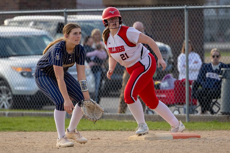 Kinley Rick (21) of Marquette stands near Streator baserunner Joyce Walkling (21) on Wednesday, April 16, 2025, at the SHS Athletic Fields in Streator.