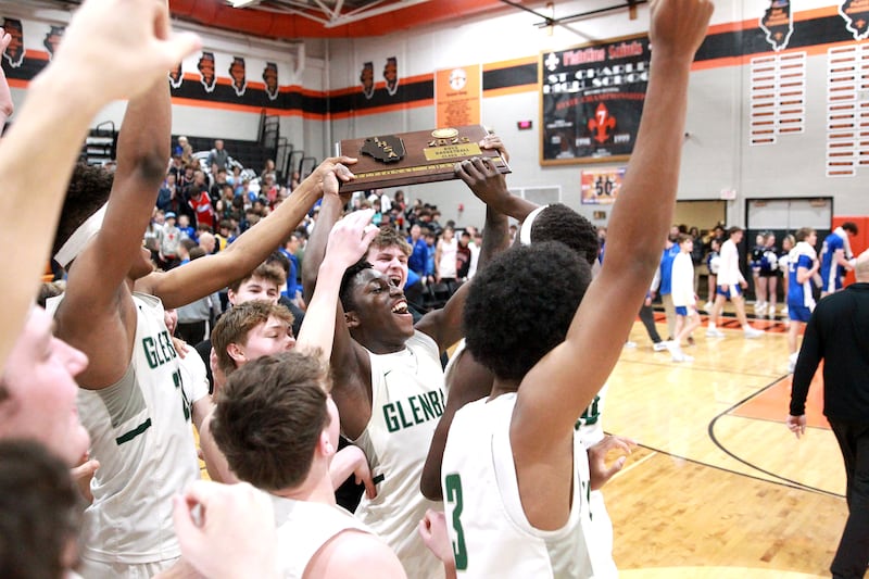 Glenbard West's Teyion Oriental (center) celebrates with his team following their Class 4A St. Charles East Sectional final win over Geneva on Friday, March 7, 2025 in St. Charles.