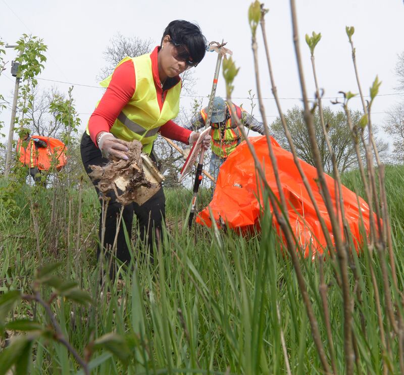 Getting into the weeds, Char Gaega was one of the many volunteers picking up trash along RT 6 west of Ottawa Monday during Operation Clean Sweep celebrating Earth Day.