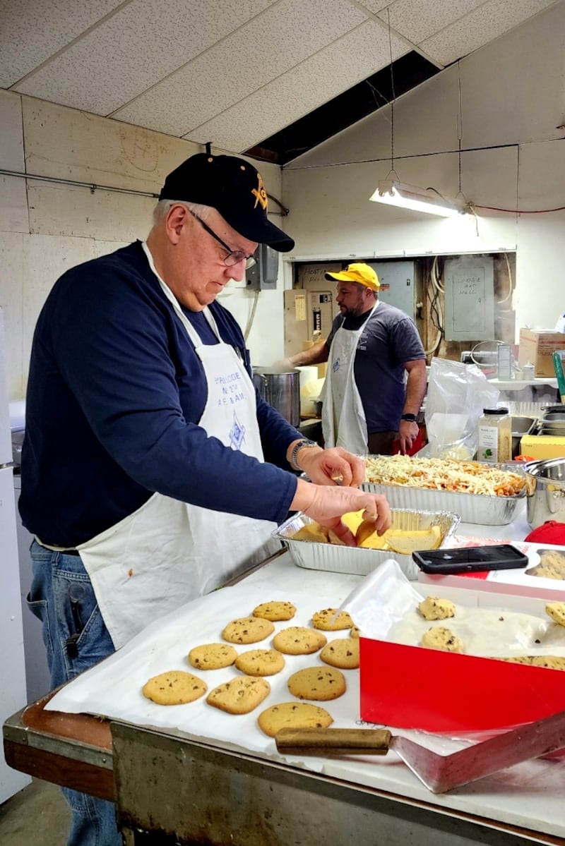 Byron Masons Brad Richolson and Sean Hosseini prepare the garlic bread and spaghetti for the fourth annual Masonic spaghetti dinner.