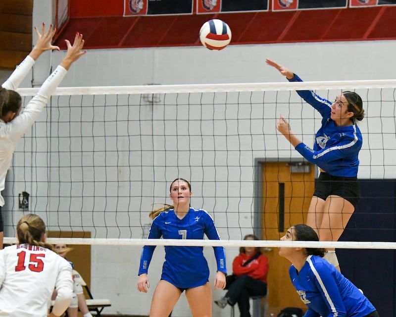 St. Charles North's Haley Burgdorf (23) spikes the ball past Benet Academy definers during the 4A sectional championship game on Thursday Nov. 7, 2024, held at West Aurora High School.