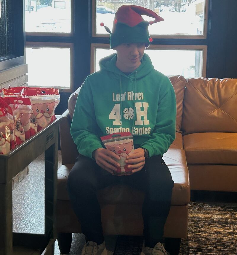 Pictured is David Wehler helping hand out treats for kids visiting Santa.