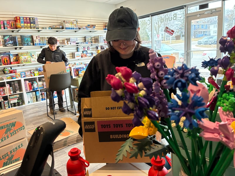 Tallulah Heath, manager of the Cary and McHenry Pieceful Project locations, helps to pack up the McHenry store on Tuesday, Feb. 24, 2025.