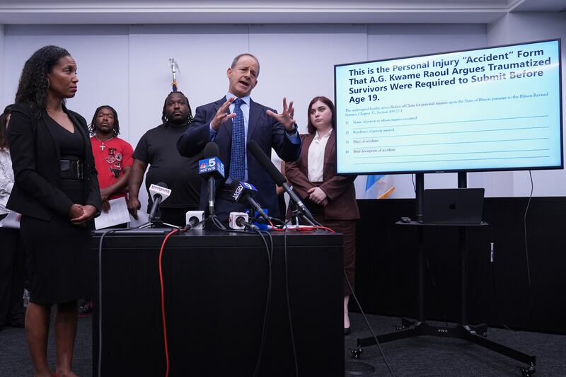 Jerome Block, partner, Levy & Konigsberg LLP, right, talks to media as attorney Kristen Feden, 1st left, listens to him during a news conference in Chicago, Wednesday, July 16, 2025. (AP Photo/Nam Y. Huh)