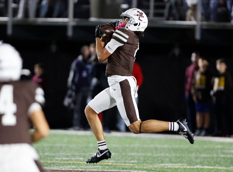 Mt. Carmel's Quentin Burell (4) makes a catch during the varsity football game between Loyola Academy and Mt. Carmel high school on Friday, Oct. 25, 2024 in Chicago.