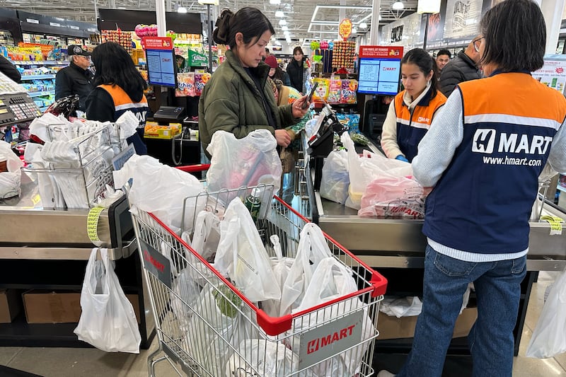 A shopper checks out at a cash register in a grocery store in Schaumburg, Ill., Monday, Feb. 9, 2026. (AP Photo/Nam Y. Huh)