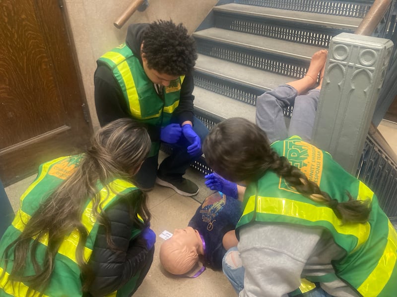 Joliet Central CERT students examine a dummy in a simulation of a student falling down the stairs and breaking multiple bones.
Thursday, Dec. 11, 2025.