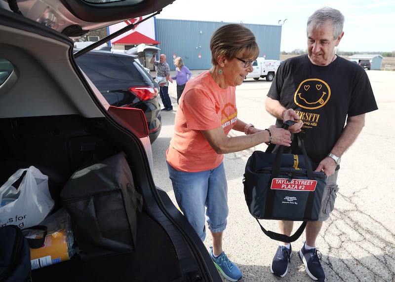 Volunteers Julie and John Ahlbach load up their van Friday, April 17, 2026, to deliver food to local residents as part of the Voluntary Action Center’s Meals on Wheels program.