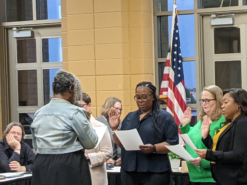 Outgoing Oswego School Board President LaTonya Simelton administers the oath of office to, from left to right, Heather Martin, Brandi Robinson, Erika Sieh and Rovel Pollock, during the May 5 Oswego School Board meeting.