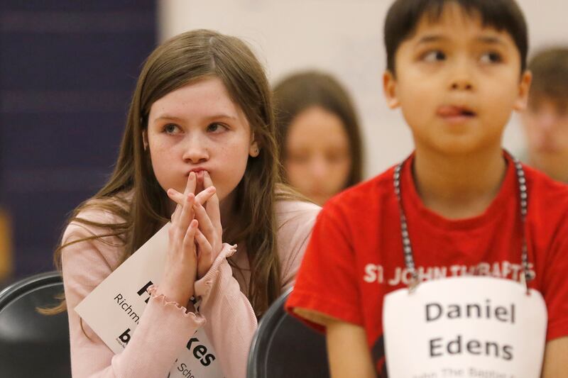 Hattie Hurckes, a student at Richmond Grade School, and Daniel Edens, a student at St. John the Baptist Catholic School, wait for their turn as they compete in the McHenry County Regional Office of Education’s 2025 Spelling Bee on Wednesday, March 19, 2025, at Bernotas Middle School in Crystal Lake.