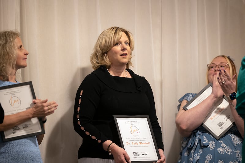Dr. Kelly Mandrell reacts after hearing she was the winner of the Crete Dillon Bowman Award for Community Leadership on Thursday, April 17, 2025, during the YWCA’s Women of Achievement Luncheon in Dixon.