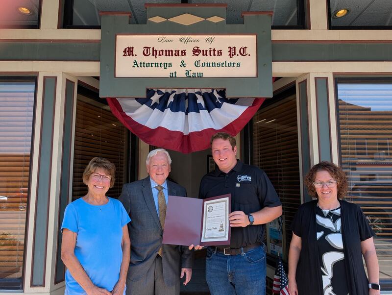 State Rep. Brad Fritts (second from right) presents his monthly business highlight award to Thomas Suits (second from left). Also pictured are Carol Suits, who is Thomas' wife, and office secretary Nicole Sofolo (right).