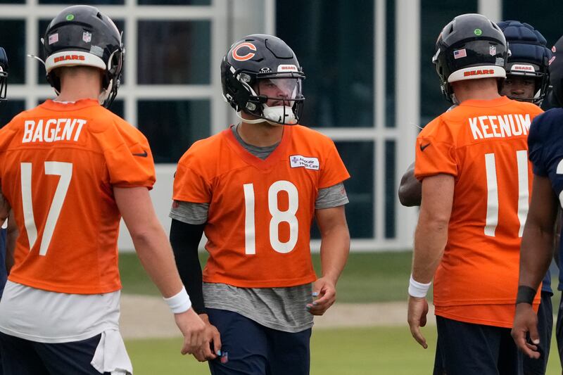 Chicago Bears quarterback Caleb Williams (18) quarterback Tyson Bagent (17) and quarterback Case Keenum (11) practices during Back Together training camp event for fans on Saturday, July 26, 2025, in Lake Forest, Ill. Chicago. (AP Photo/David Banks)
