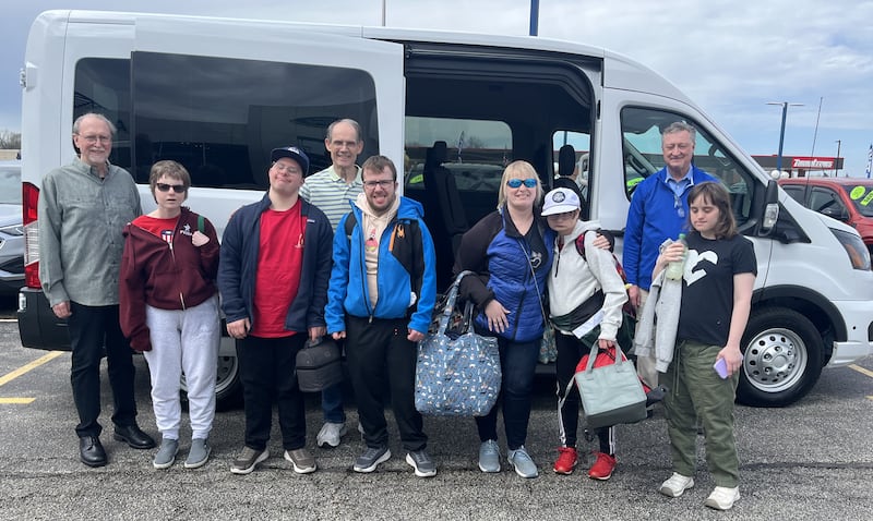 Clients and volunteers of the Joshua Tree Community, based in Geneva, stand with their new $68,000 12-passenger van purchased from Hawk Ford of St. Charles. The nonprofit serves intellectually disabled adults.