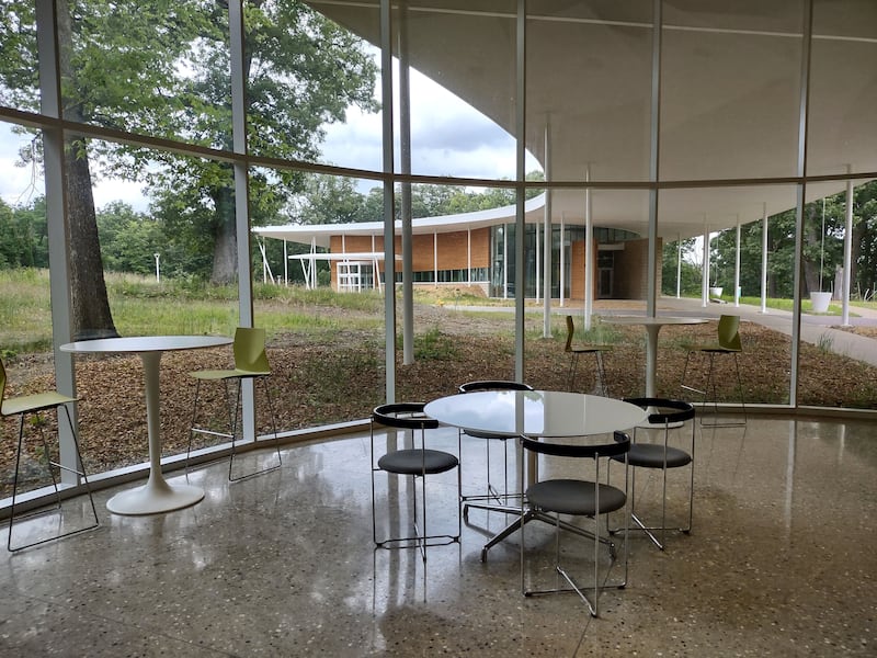 A kitchenette and seating area in the Health and Wellness Building at Nell's Woodland gives visitors a space to relax and view the grounds.