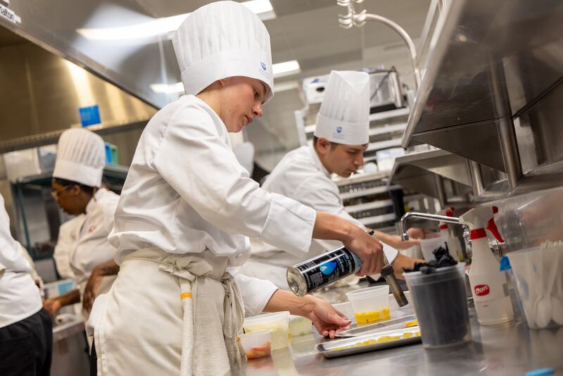 Joliet Junior College culinary arts program. taken in 2023 of our then-student competition team during a practice. JJC PR said: I think they illustrate the action and dynamics of the training kitchens at City Center campus.