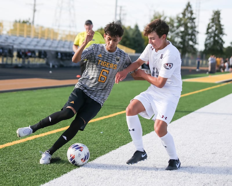 Joliet West's Ronaldo Aguirre (6) battles Plainfield North's Kaden Palmerin (15) along the sidelines during soccer match between Plainfield North at Joliet West. Sept 9, 2025.