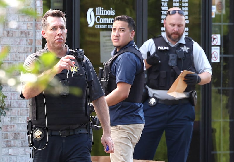 DeKalb Police officers work outside the Illinois Community Credit Union Wednesday, July 31, 2024, as they investigate a morning bank robbery in the facility at 1500 Barber Greene Road in DeKalb.
