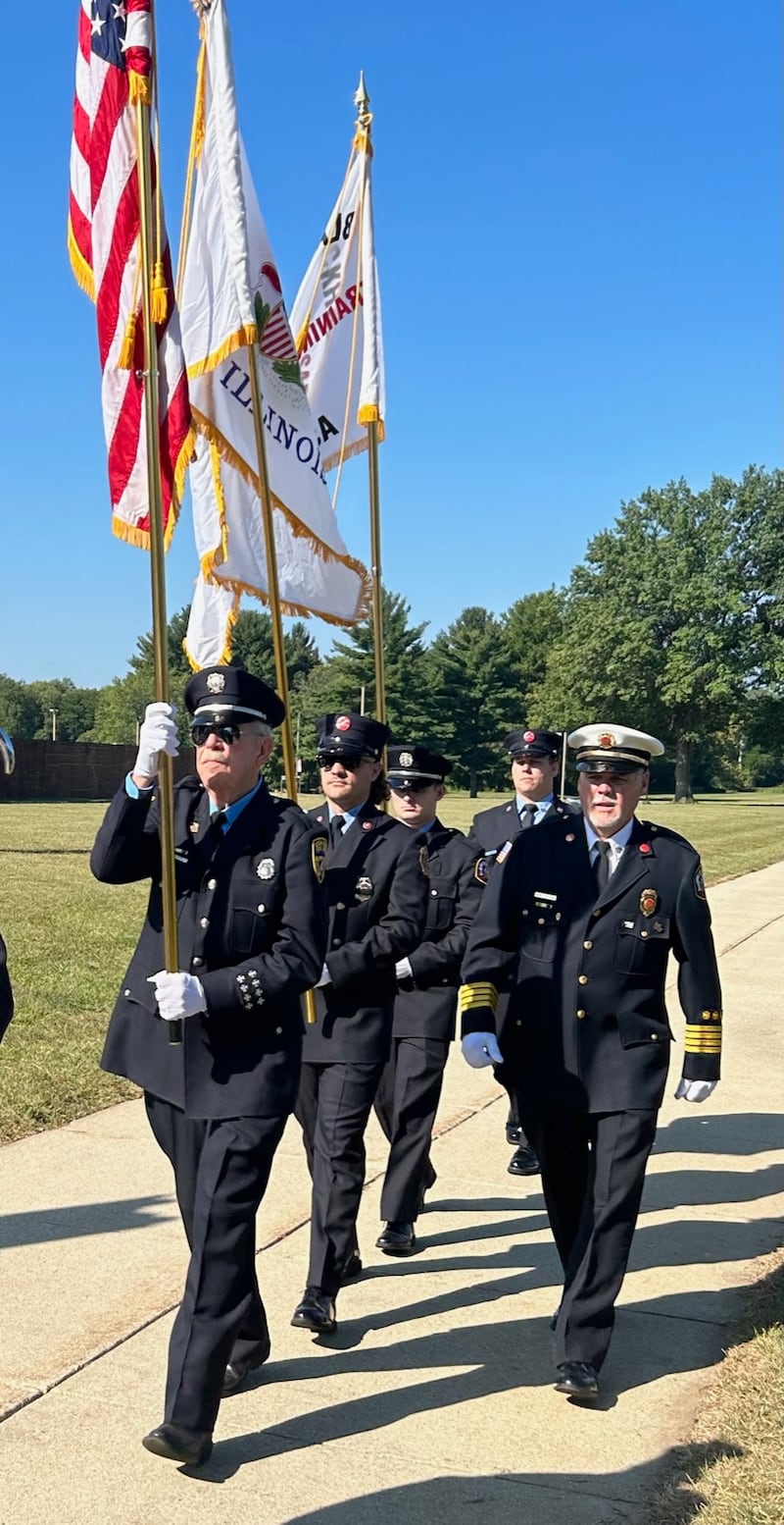 Retired Dixon Fire Deputy Chief Mark Callison, right, directs the combined Color Guard of the American Legion, VFW and Blackhawk Firefighters Association during the Presentation of Colors on Saturday at Sauk Valley Community College.