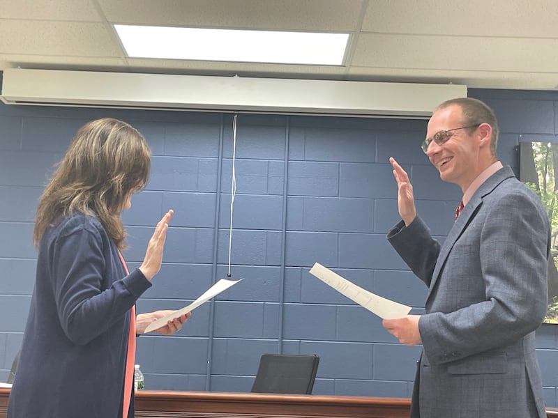 Utica Mayor David Stewart (right) shares a laugh with village clerk Laurie Gbur before taking the oath of office Thursday, May 8, 2025. Stewart was unopposed at the April 1 election.