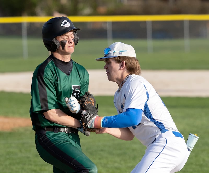 Newman’s Garet Wolfe tags out Rock Falls’ Owen Mandrell at first base Wednesday, April 23, 2025.