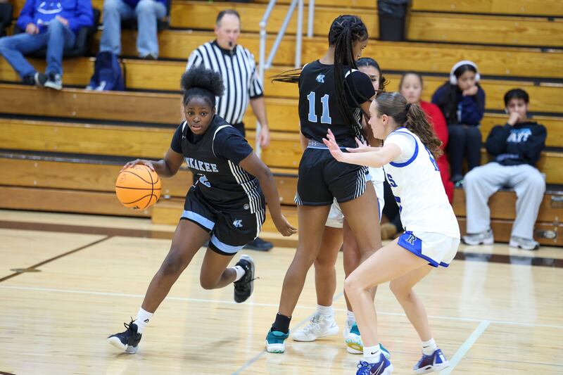 Kankakee's London Stroud dribbles off a pick by teammate Shania Johnson (11) during the Kays' 75-28 victory over Rosary at the Reed-Custer Classic on Monday, Nov. 17, 2025.