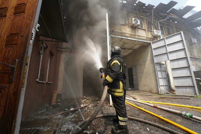 Firefighters tackle the blaze after a Russian attack that hit a residential area in Kharkiv, Ukraine, Thursday, July 24, 2025. (AP Photo/Andrii Marienko)