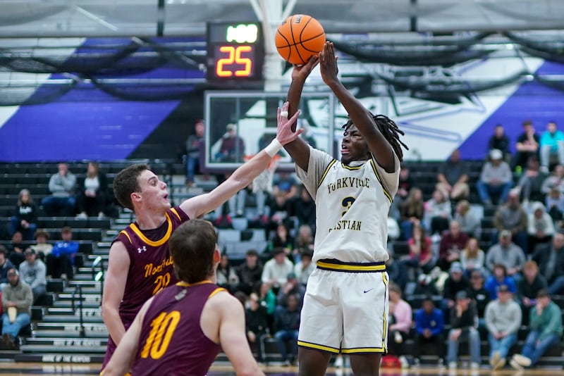 Yorkville Christian's Jayden Riley (3) shoots a three pointer over Northridge Prep's Linus Coleman (20) during a semi-final basketball game in the 61st annual Plano Christmas Classic at Plano High School on Friday, December 27, 2024.