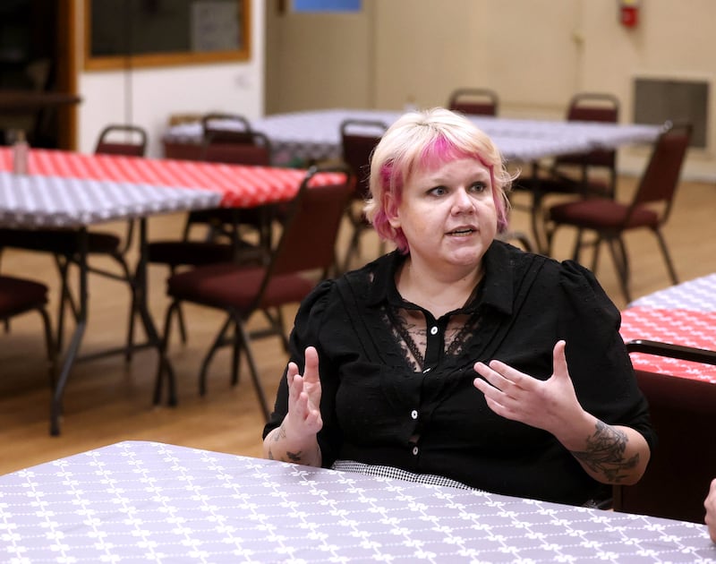 Ash Rootes, director of the overnight warming center at the Unitarian Universalist Fellowship of DeKalb, talks Thursday, Jan. 23, 2025, at the church, about the main eating and sleeping area at the facility. The warming center, which is open nightly during the winter months, offers free hot meals to all and a warm, safe place for community members.