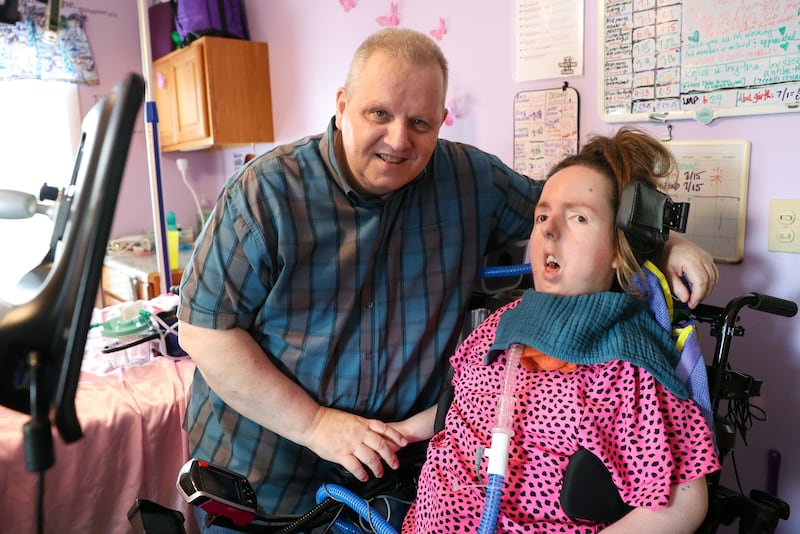 Lauren Gross and her father, David, left, pose for a photo in their Bradley home last week. Lauren, who was born with Spinal Muscular Atrophy with a life expectancy of 3-4 years, will be celebrating her 30th birthday next Saturday with an open house party at Brookmont Bowling from 1 - 4 p.m.