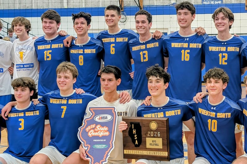 Wheaton North's volleyball players pose with the championship plaque after beating Wheaton-Warrenville South 27-25, 24-26, 25-21 in the Larkin Sectional final Tuesday, June 2, 2026, at Larkin High School in Elgin.